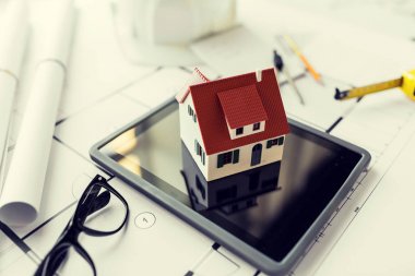close up of living house model on tablet pc clipart