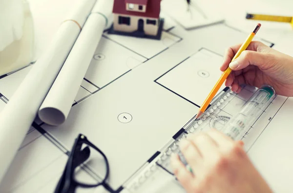 Close up of hands with ruler measuring blueprint — Stock Photo, Image