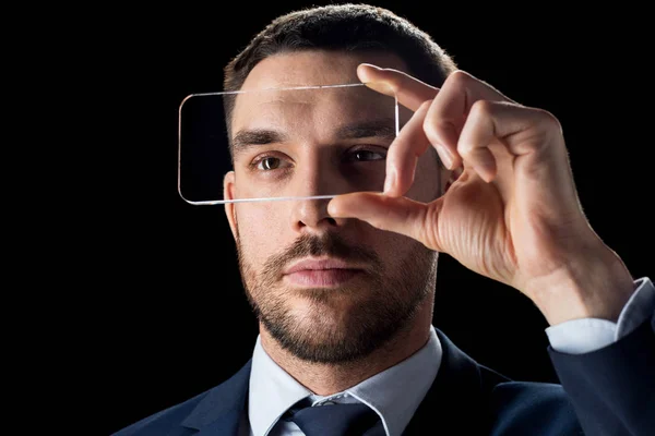 Businessman with transparent smartphone — Stock Photo, Image