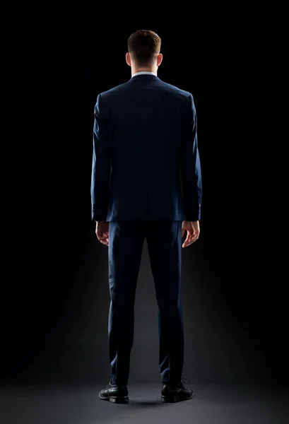 Hombre de negocios en traje sobre negro — Foto de Stock