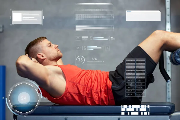 Young man making abdominal exercises in gym — Stock Photo, Image