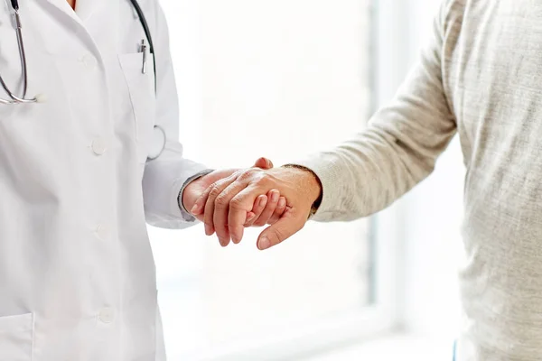 Close up of doctor holding old man hand — Stock Photo, Image