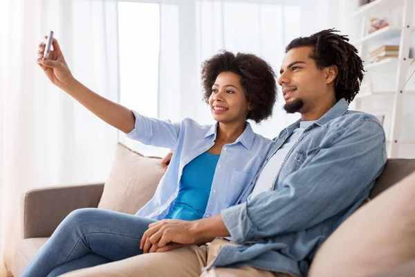 Ευτυχισμένο ζευγάρι με smartphone λήψη selfie στο σπίτι — Φωτογραφία Αρχείου