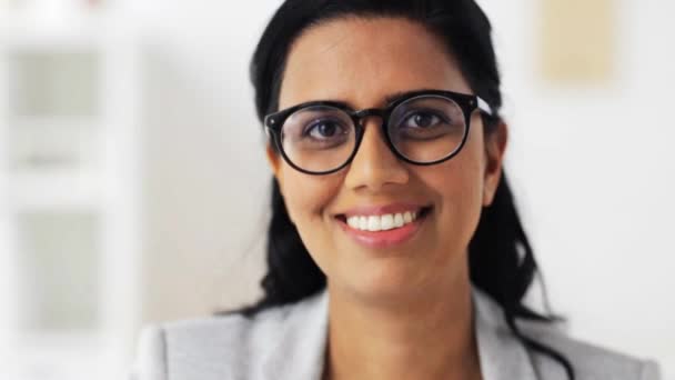 Face of happy smiling young woman in glasses — Stock Video