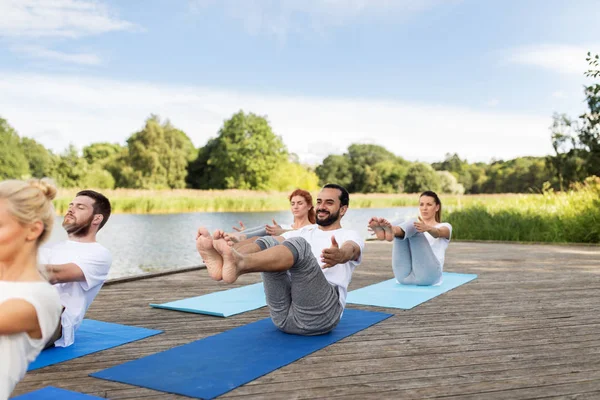 Persone che fanno yoga in mezza barca posa all'aperto — Foto Stock