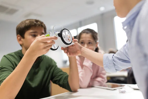 Happy children building robots at robotics school — Stock Photo, Image