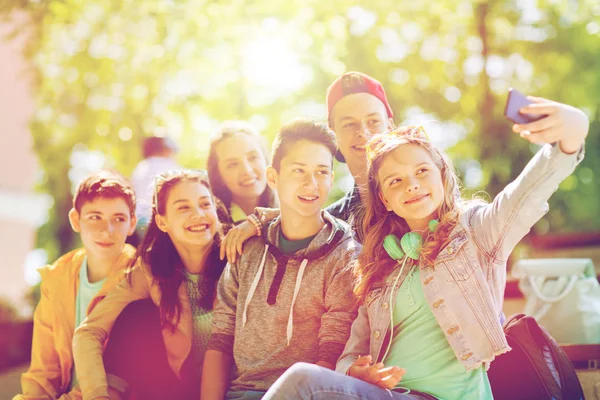 Szczęśliwy nastoletnich uczniów biorąc selfie przez smartfona — Zdjęcie stockowe