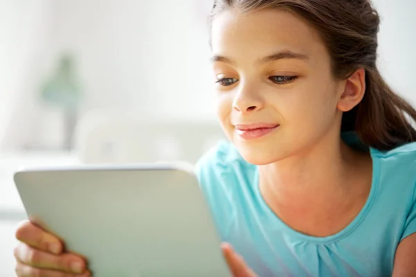 Tablet pc を家庭で微笑んでいる女の子のクローズ アップ — ストック写真