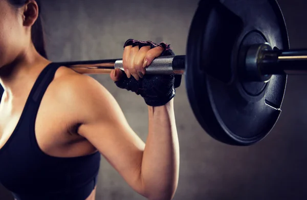 Close up of woman with barbell in gym — Stock Photo, Image
