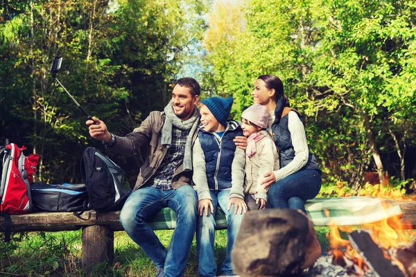 Family with smartphone taking selfie near campfire — Stock Photo, Image