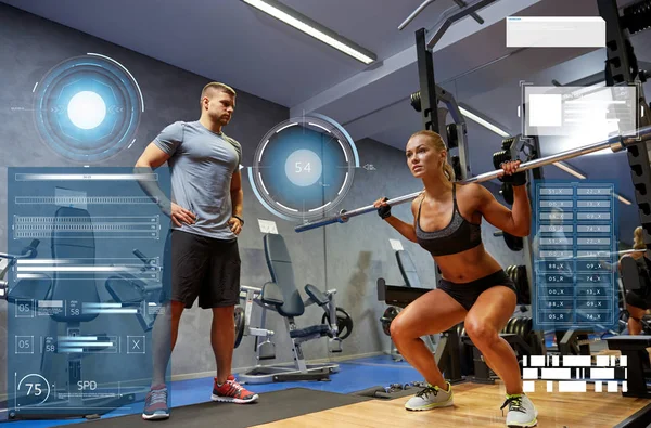 Man and woman with bar flexing muscles in gym — Stock Photo, Image