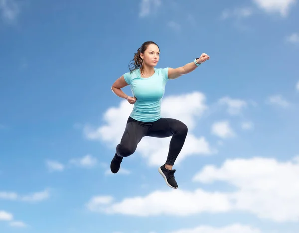 Heureuse jeune femme sportive sautant dans la pose de combat — Photo