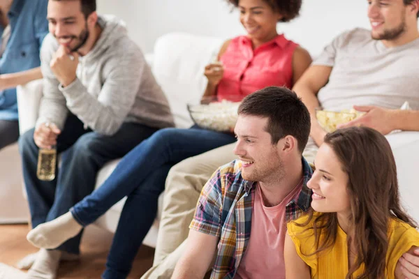 Amigos felizes assistindo tv em casa — Fotografia de Stock