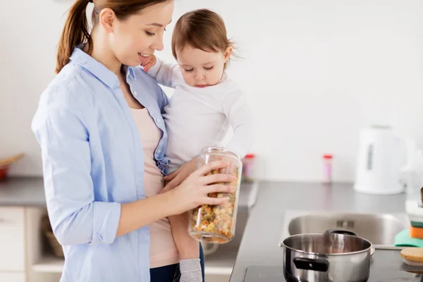 Mother and baby cooking pasta at home kitchen — Stock Photo, Image