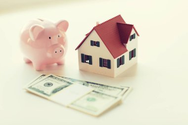 close up of house model, piggy bank and money clipart