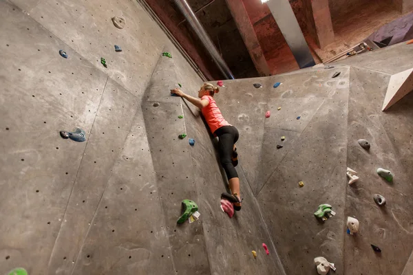 Mujer joven haciendo ejercicio en el gimnasio de escalada interior —  Fotos de Stock