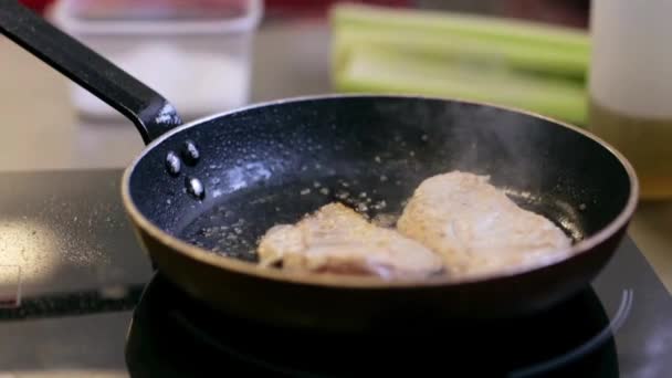 Hands of male chef cook frying meat in kitchen — Stock Video