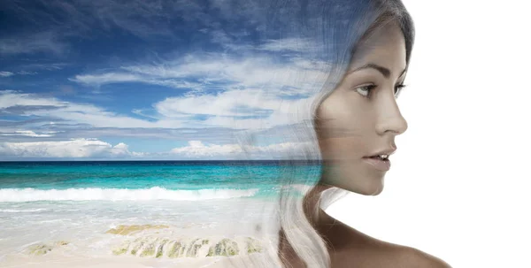 Beautiful young woman face over beach background — Stock Photo, Image