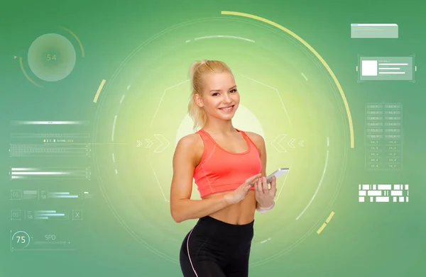 Mujer deportiva sonriente con teléfono inteligente —  Fotos de Stock