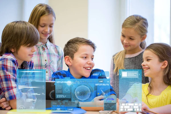 Group of school kids with tablet pc in classroom — Stock Photo, Image