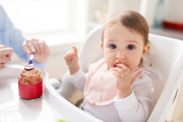 Mother feeding baby with puree at home — Stock Photo, Image