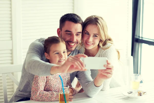 Happy family taking selfie at restaurant — Stock Photo, Image