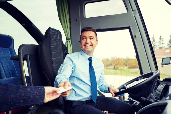 Bus driver taking ticket or card from passenger — Stock Photo, Image