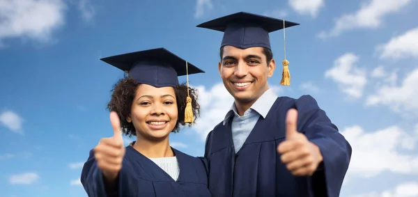 Happy students or bachelors showing thumbs up — Stock Photo, Image