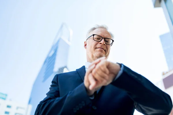 Senior zakenman controleren tijd op zijn polshorloge — Stockfoto