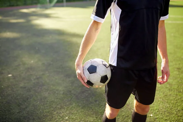 Voetbalspeler met bal op voetbalveld — Stockfoto