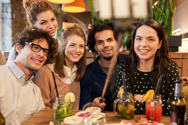Friends taking selfie by smartphone at bar or cafe — Stock Photo, Image