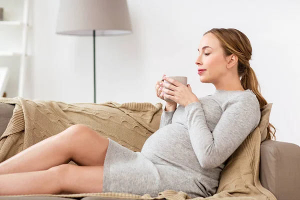 Mujer embarazada feliz con taza de té en casa — Foto de Stock