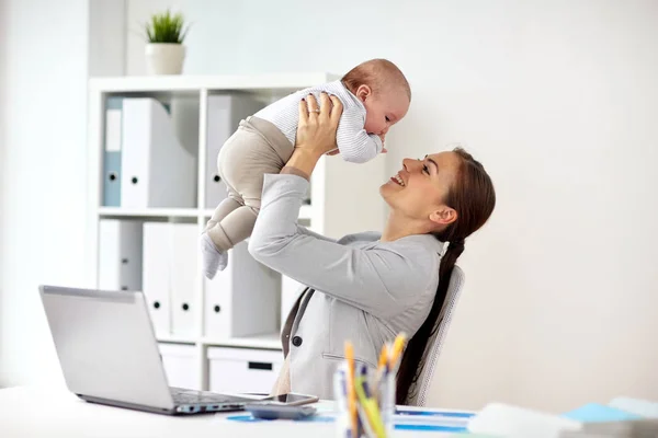 婴儿和笔记本电脑在办公室的快乐的女商人 — 图库照片