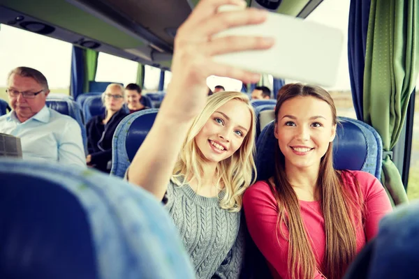 Women taking selfie by smartphone in travel bus — Stock Photo, Image