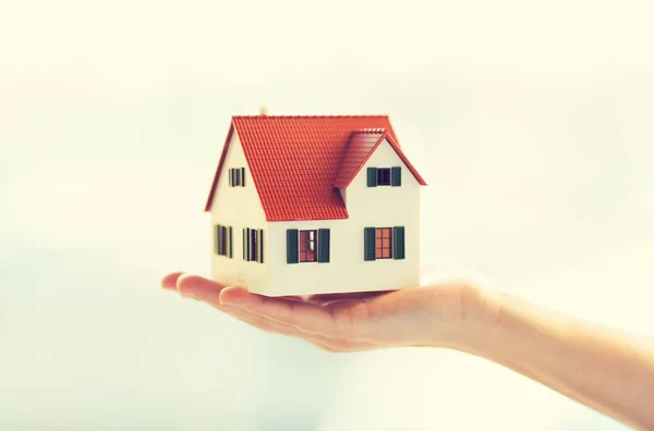 Close up of hands holding house or home model — Stock Photo, Image