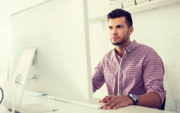 Creative man or student with computer at office — Stock Photo, Image