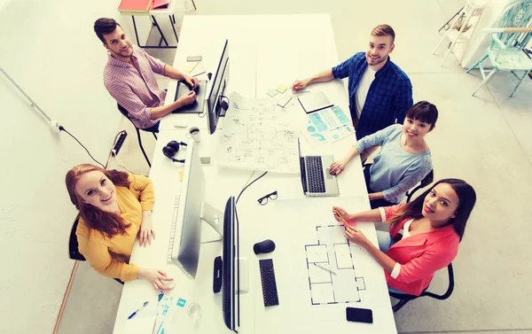 Creative team with computers, blueprint at office — Stock Photo, Image