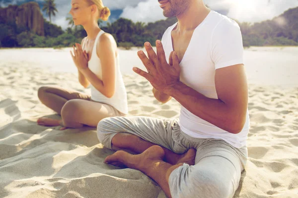 Close up of couple making yoga exercises outdoors — Stock Photo, Image