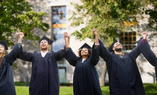 Happy students or bachelors celebrating graduation — Stock Photo, Image