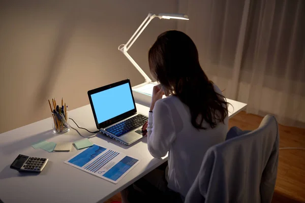 Businesswoman with laptop at night office — Stock Photo, Image