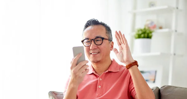スマート フォンを自宅でビデオ通話を持つ幸せな男 — ストック写真