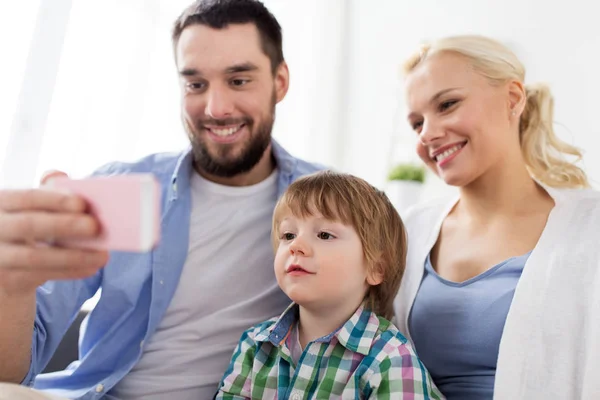 Gelukkig gezin met smartphone thuis — Stockfoto