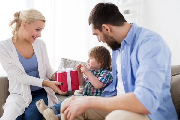 Happy family with birthday gift at home — Stock Photo, Image