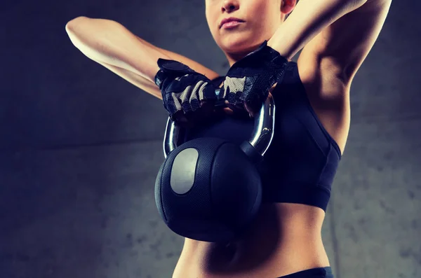 Close up of woman with kettlebell in gym — Stock Photo, Image