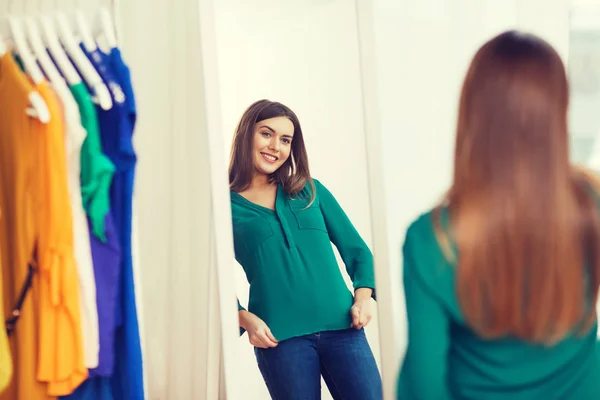 Счастливая женщина позирует перед зеркалом в домашнем шкафу — стоковое фото