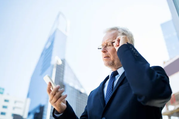 Hombre de negocios senior con smartphone en la ciudad —  Fotos de Stock