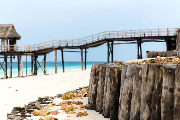 Most na palach do hut bungalow na tropikalnej plaży — Zdjęcie stockowe