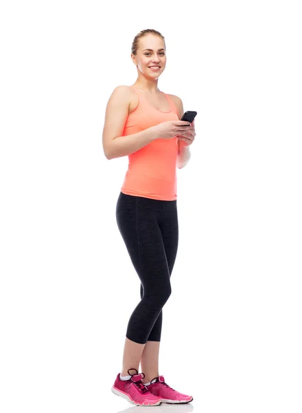 Felice sorridente sportiva giovane donna con smartphone — Foto Stock