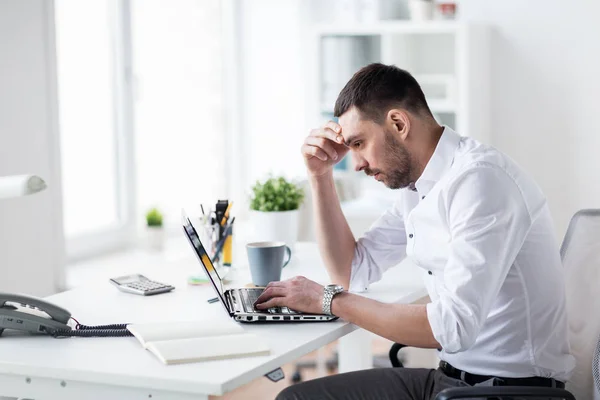 Empresario estresado con el ordenador portátil en la oficina —  Fotos de Stock
