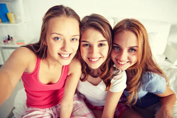 Happy friends or teen girls taking selfie at home — Stock Photo, Image